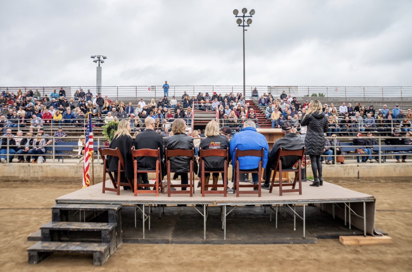 Celebration of Life for racing champion Ron Esau in the Lakeside Rodeo arena, with family and a full grandstand of the community gathered to honor him